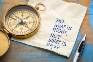 Do what is right, not what is easy  advice or reminder - handwriting on a napkin with an antique brass compass